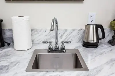 a kitchen counter with a sink and a coffee maker at Premier Location with Great Scenic Downtown View in San Diego