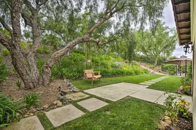 a bench sitting next to a tree in a yard at Rancho Santa Fe Casita - Gate Guarded Community! in Rancho Santa Fe