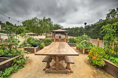 a wooden table in a garden with a gazebo at Rancho Santa Fe Casita - Gate Guarded Community! in Rancho Santa Fe