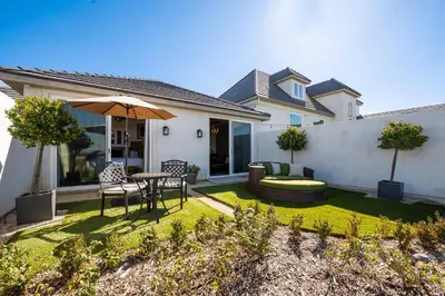 a backyard with a table and chairs and an umbrella at Domaine Chardonnay in Temecula