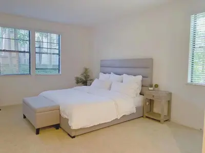 a white bedroom with a large bed and two windows at Irvine 2Bedroom 2 Bathroom Apartment with Kitchen Pool gym in Irvine