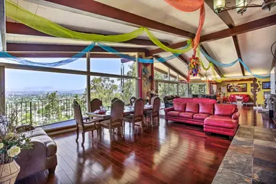 a dining room with a table and chairs at Colorful El Cajon Gem Deck, Garden and Valley Views in El Cajon