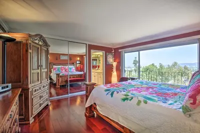 a bedroom with a bed and a large window at Colorful El Cajon Gem Deck, Garden and Valley Views in El Cajon