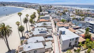 an aerial view of a beach with houses and palm trees at Highly rated Best Beach! AC Luxury KING Beds! in San Diego