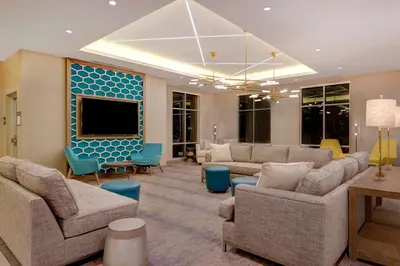 a living room with couches and a flat screen tv at Hilton Garden Inn Temecula in Temecula