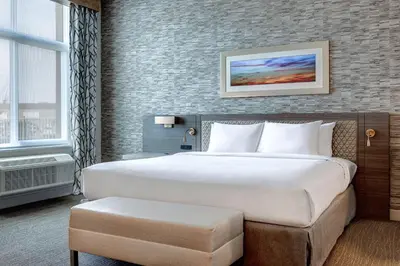 a hotel room with a large bed and a window at Hilton Garden Inn Temecula in Temecula
