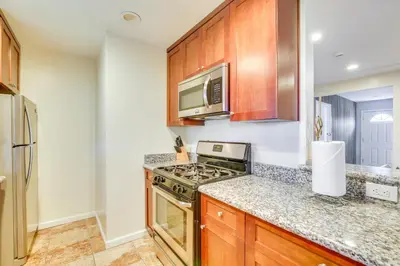 a kitchen with a stove and a microwave at Modern Duplex Near Gaylord Resort and Bayfront! in Chula Vista