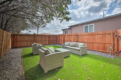 a backyard with two couches and a fence at Modern Duplex Near Gaylord Resort and Bayfront! in Chula Vista