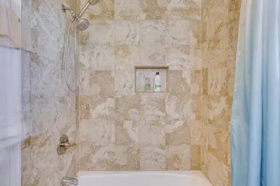 a bathroom with a shower with a sink and a tub at 1 Mi to Gaylord Resort and Bayfront Updated Duplex in Chula Vista