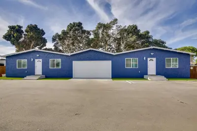 a blue house with a white garage at 1 Mi to Gaylord Resort and Bayfront Updated Duplex in Chula Vista