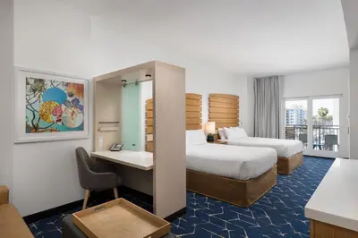a hotel room with two beds and a desk at SpringHill Suites by Marriott Oceanside Beach in Oceanside