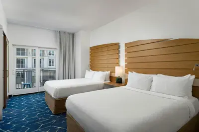 a hotel room with two beds and a window at SpringHill Suites by Marriott Oceanside Beach in Oceanside