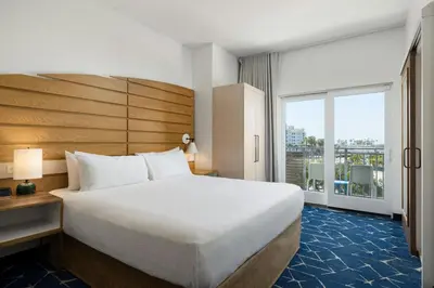 a bedroom with a large bed and a large window at SpringHill Suites by Marriott Oceanside Beach in Oceanside