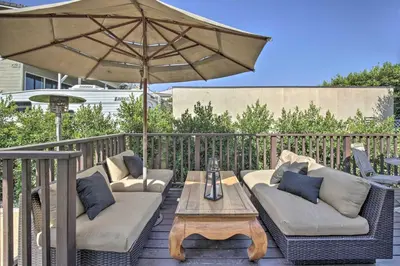 a patio with two couches and a table with an umbrella at Serene San Diego Retreat with Deck - Walk to Bay! in San Diego