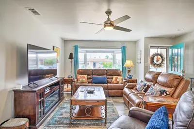 a living room with a couch and a flat screen tv at San Marcos Home with Patio and Grill - Walk to Lake! in San Marcos