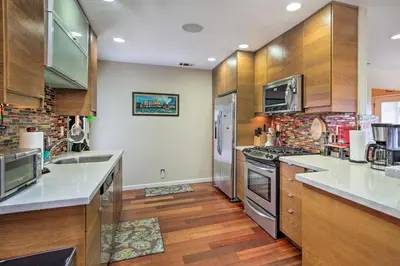 a kitchen with stainless steel appliances and wooden cabinets at Updated San Diego Home with Private Yard and Patio! in San Diego