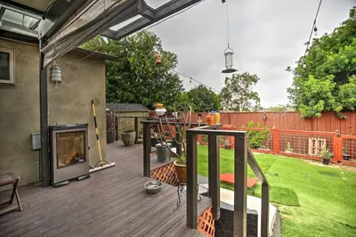 a backyard with a deck with a fireplace at Updated San Diego Home with Private Yard and Patio! in San Diego