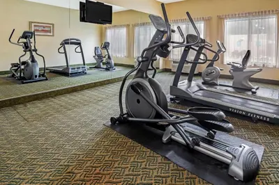 a fitness room with cardio machines and a flat screen tv at La Quinta by Wyndham Temecula in Temecula