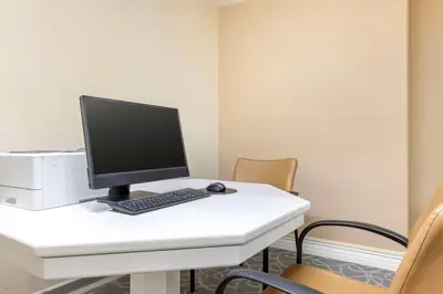 a computer on a white desk with chairs at Hilton Vacation Club Riviera Beach & Shores in Capistrano Beach