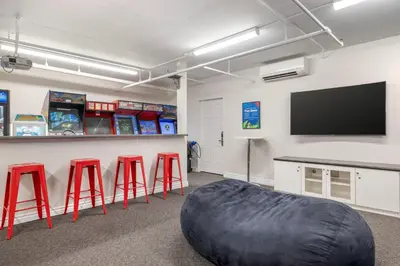 a room with stools and a tv and a bean bag at Hilton Vacation Club Riviera Beach & Shores in Capistrano Beach