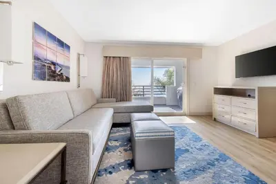 a living room with a couch and a tv at Hilton Vacation Club Riviera Beach & Shores in Capistrano Beach