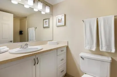 a bathroom with a sink and a toilet and a mirror at Hilton Vacation Club Riviera Beach & Shores in Capistrano Beach