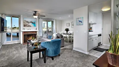 a living room with a couch and a fireplace at New Listing Ocean and Harbor View Cottage in Beach Resort in Oceanside