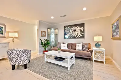 a living room with a couch and a table at Enchanting Cottage By the Sea in Carlsbad