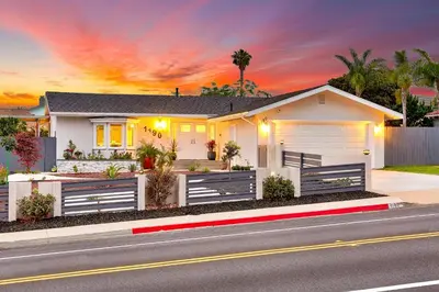 a house on a street with a sunset at Enchanting Cottage By the Sea in Carlsbad