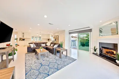 a living room with a couch and a fireplace at Enchanting Cottage By the Sea in Carlsbad