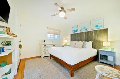 a bedroom with a bed and a ceiling fan at Mission Beach Getaway in San Diego