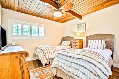 a bedroom with two beds and a ceiling fan at California Getaway in San Clemente
