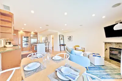a dining room and living room with a table and chairs at Sea & Sand Ocean Views in San Diego