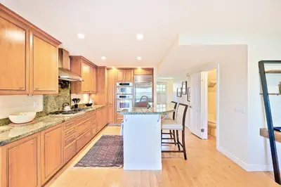 a kitchen with wooden cabinets and a counter top at Sea & Sand Ocean Views in San Diego