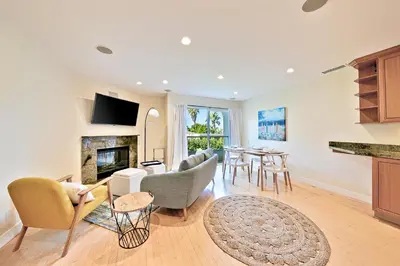 a living room with a table and chairs and a fireplace at Sea & Sand Ocean Views in San Diego