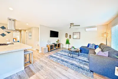 a living room with a couch and a table at New Tremont Modern Beach in Oceanside