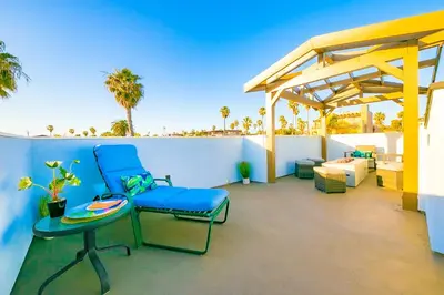 a patio with a blue chair and a table at New Tremont Modern Beach in Oceanside