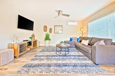 a living room with a couch and a tv at New Tremont Modern Beach in Oceanside