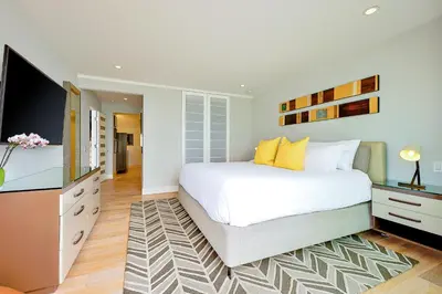 a bedroom with a bed and a flat screen tv at Seabluffe Ocean Spray in Encinitas
