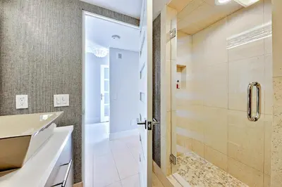 a bathroom with a shower and a sink at Seabluffe Ocean Spray in Encinitas