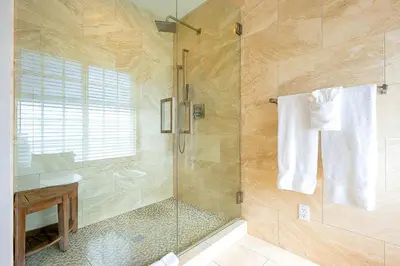 a bathroom with a shower with a glass door at La Jolla Scenic Retreat in San Diego