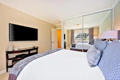 a bedroom with a large bed and a television at La Jolla Scenic Retreat in San Diego