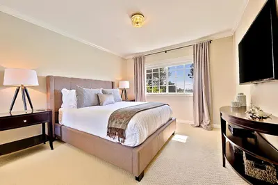 a bedroom with a large bed and a television at La Jolla Scenic Retreat in San Diego