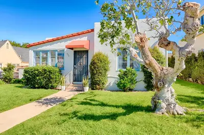 a house with a tree in front of it at Seashell Cottage in San Diego