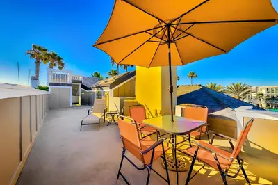 a patio with a table and chairs and an umbrella at Great Balboa Peninsula Combo in Newport Beach