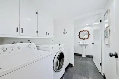 a white bathroom with a washing machine and a sink at Great Balboa Peninsula Combo in Newport Beach