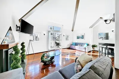a living room with a couch and a table at Great Balboa Peninsula Combo in Newport Beach