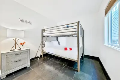 a bedroom with a bunk bed and a desk at Great Balboa Peninsula Combo in Newport Beach