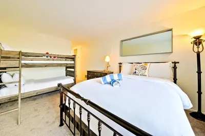 a bedroom with two bunk beds and a mirror at Pier View Retreat in Oceanside