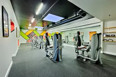 a gym with several tread machines in a room at Pier View Retreat in Oceanside